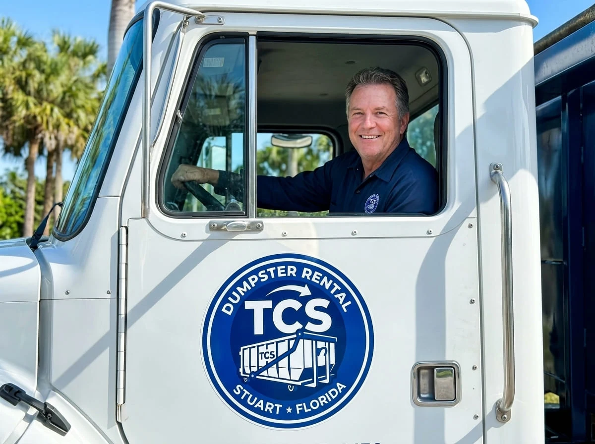 Our team, on the road A TCS Dumpster Rental driver ready for delivery in Stuart, FL